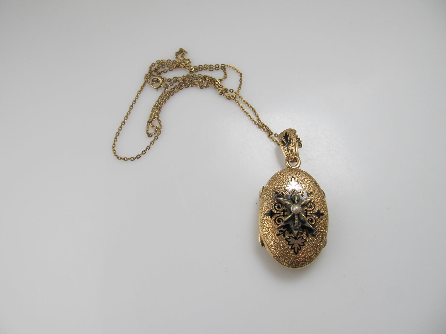 Victorian gold locket with enamel and a pearl