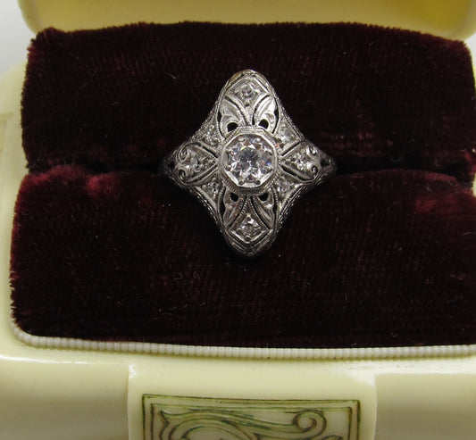 19k white gold filigree ring with a .25ct center OEC diamond.   Circa 1920.