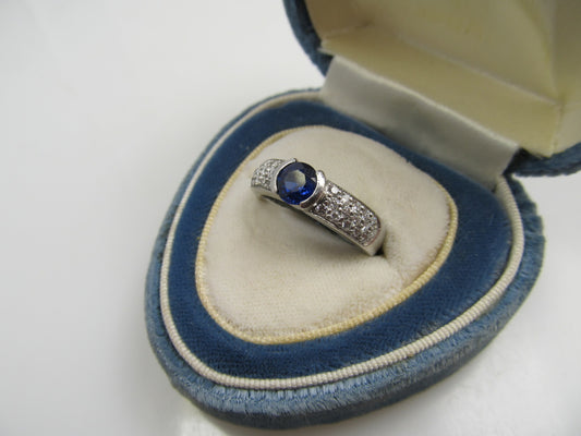 Platinum Ring With A .50ct Sapphire And .50cts Tw In Diamonds.