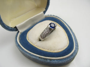 Platinum Ring With A .50ct Sapphire And .50cts Tw In Diamonds.