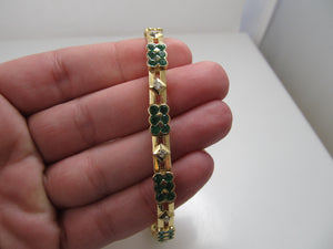 14k yellow gold line bracelet with emeralds and diamonds