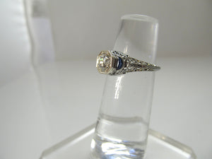 Dated 1928, 18k white gold filigree sapphire diamond ring