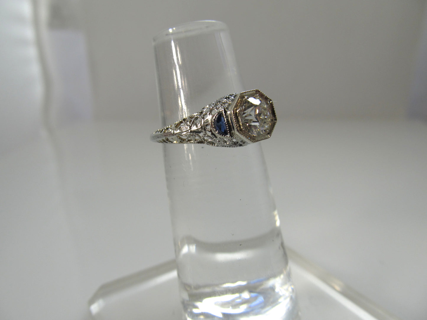 Dated 1928, 18k white gold filigree sapphire diamond ring