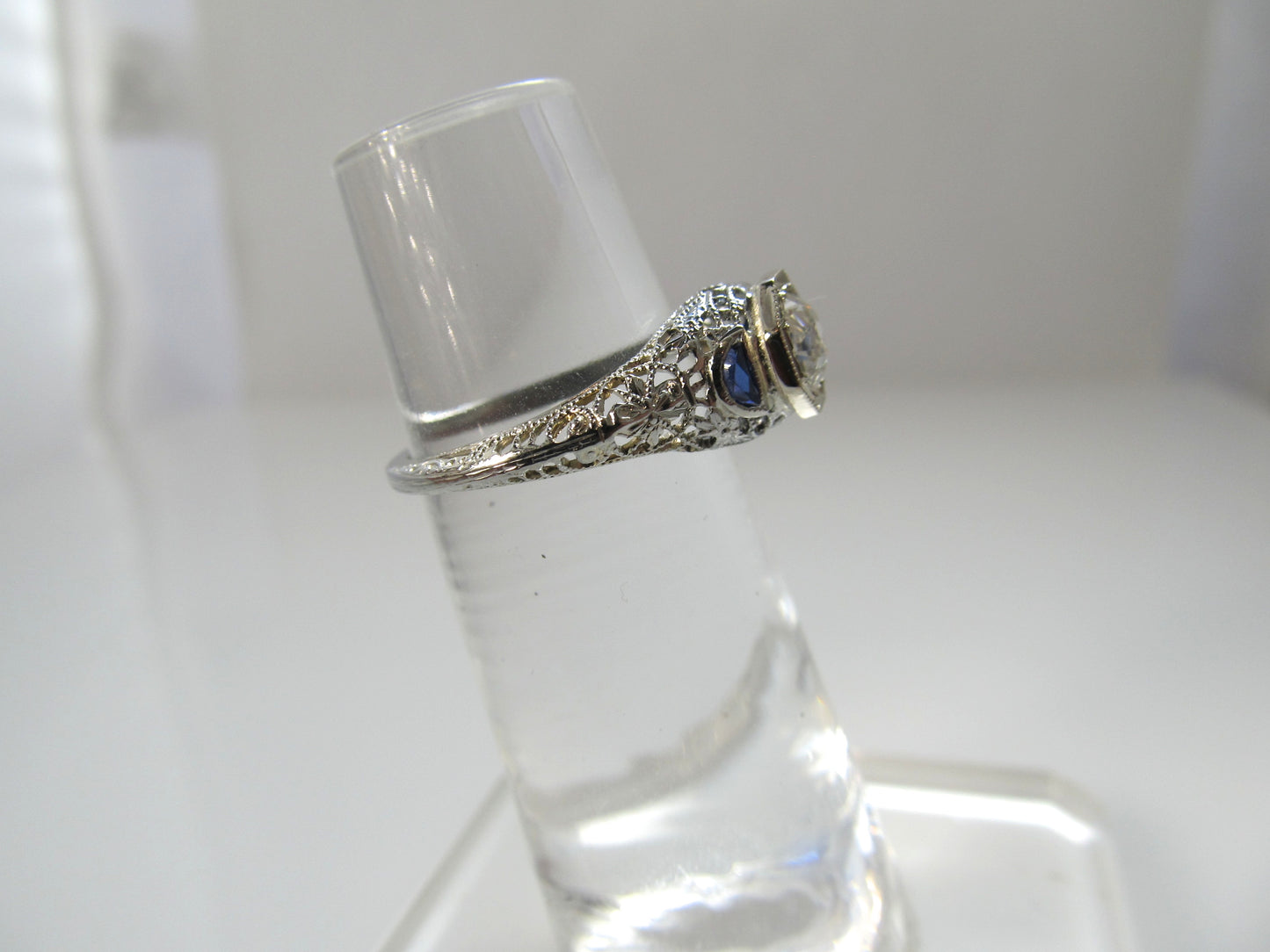 Dated 1928, 18k white gold filigree sapphire diamond ring