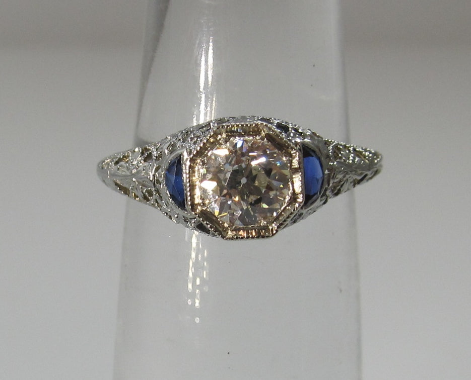 Dated 1928, 18k white gold filigree sapphire diamond ring