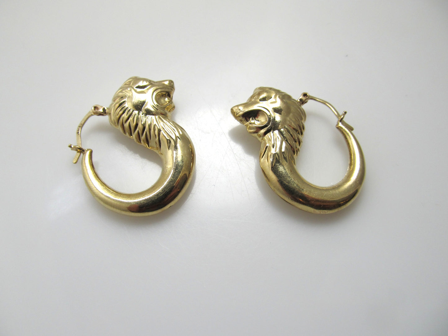 Yellow gold lion head hoop earrings