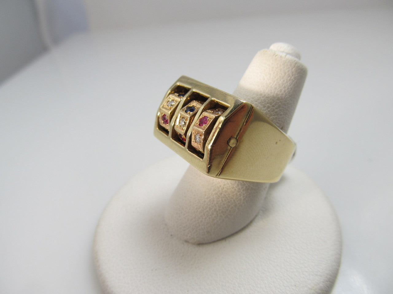 14k yellow gold "slot machine" style ring with ruby, sapphire and diamonds.