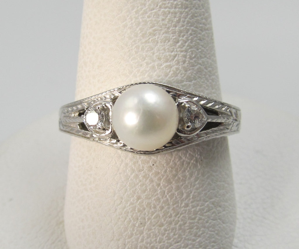 14k white gold ring with diamonds and a pearl