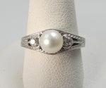 14k white gold ring with diamonds and a pearl