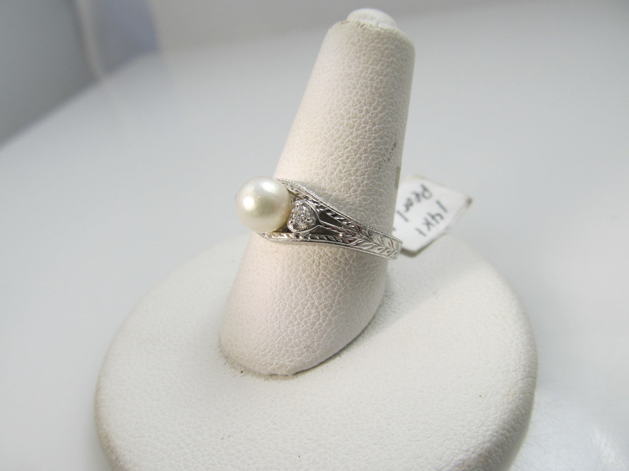 14k white gold ring with diamonds and a pearl