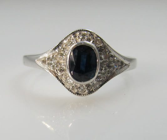 14k white gold ring with a .25ct sapphire and diamonds