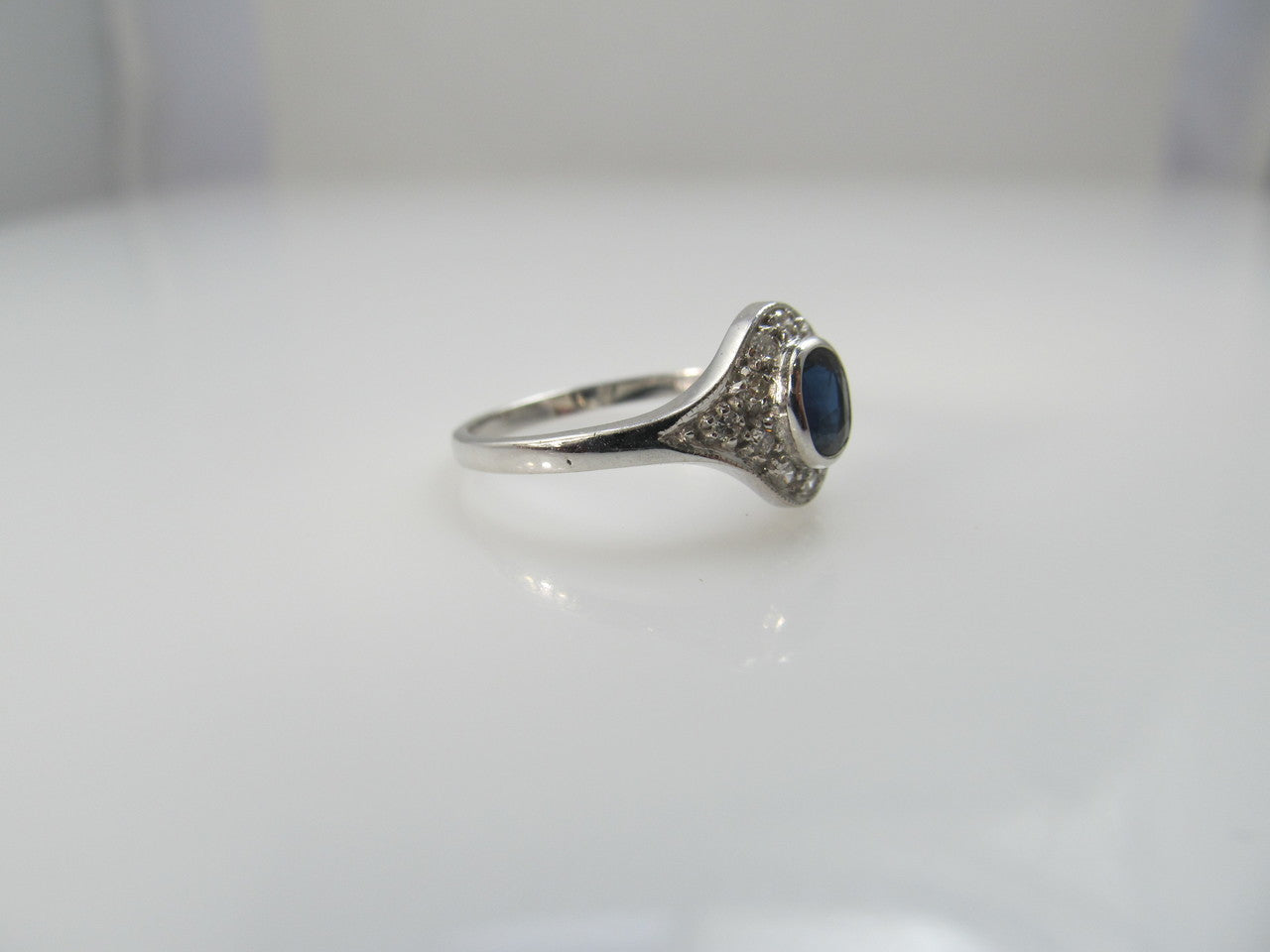 14k white gold ring with a .25ct sapphire and diamonds