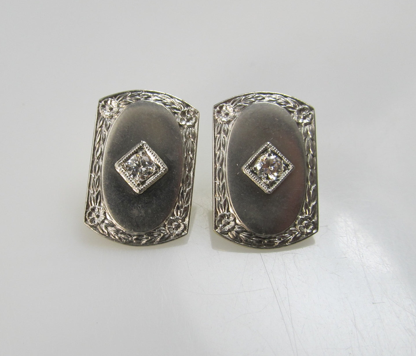 14k and platinum earrings with .20cts in diamonds, circa 1920.