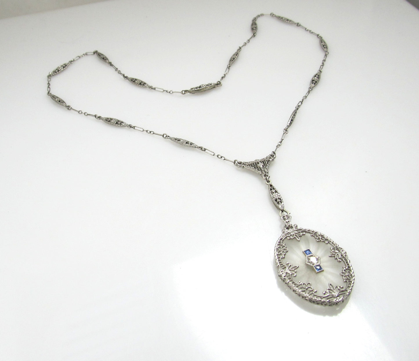 14k White Gold Filigree Necklace With A Diamond, Sapphires And Camphor Glass, Circa 1920