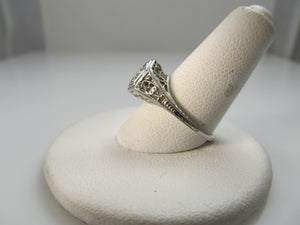 18k white gold filigree ring with a .33ct center diamond, circa 1920