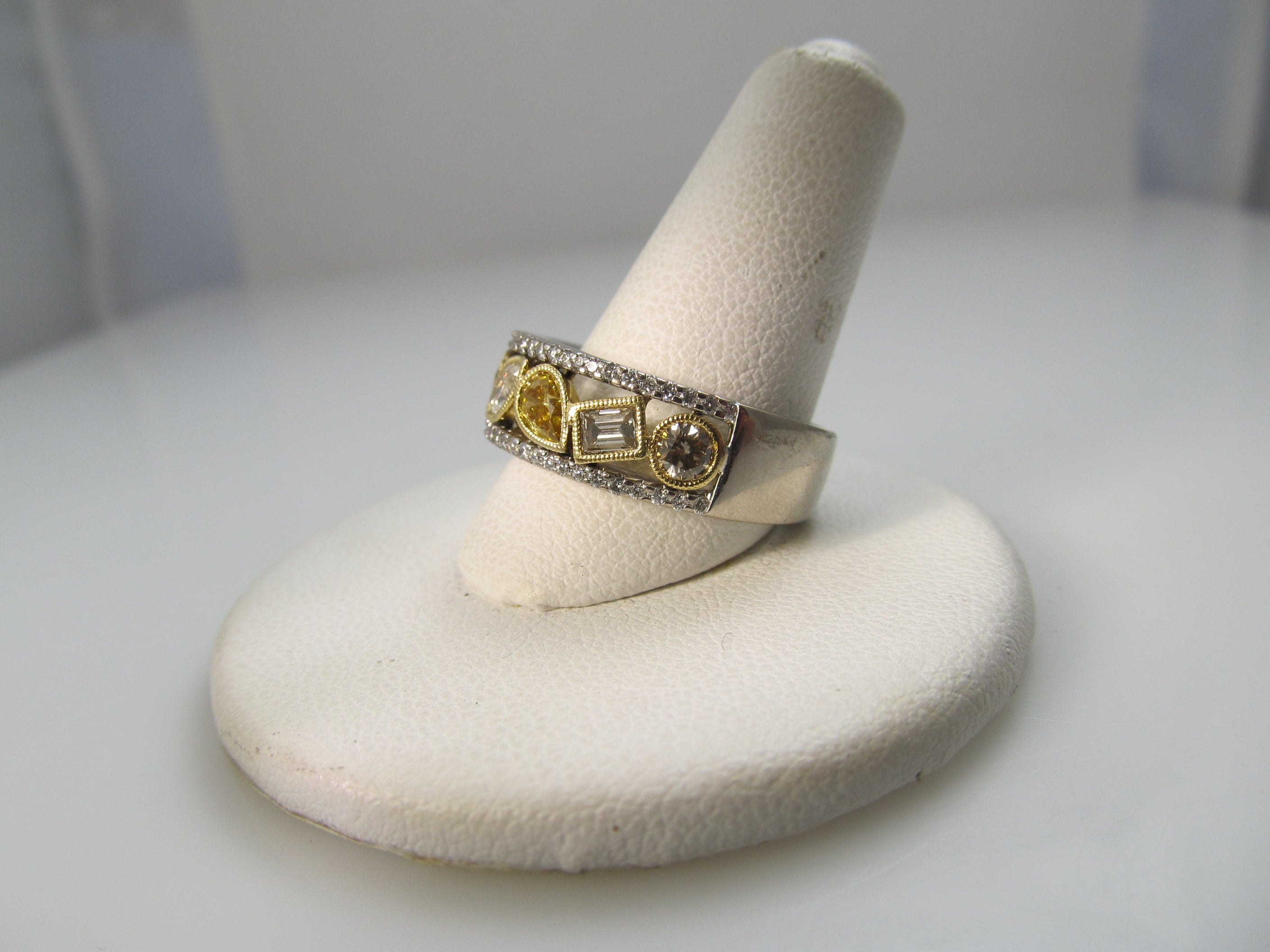 18k white gold band, 1.50ct in fancy yellow diamonds