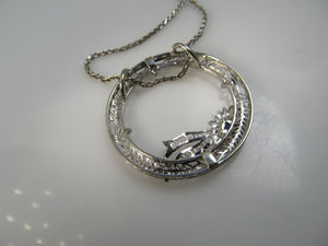 14k white gold filigree circle necklace with a sapphire, circa 1920