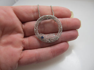 14k white gold filigree circle necklace with a sapphire, circa 1920