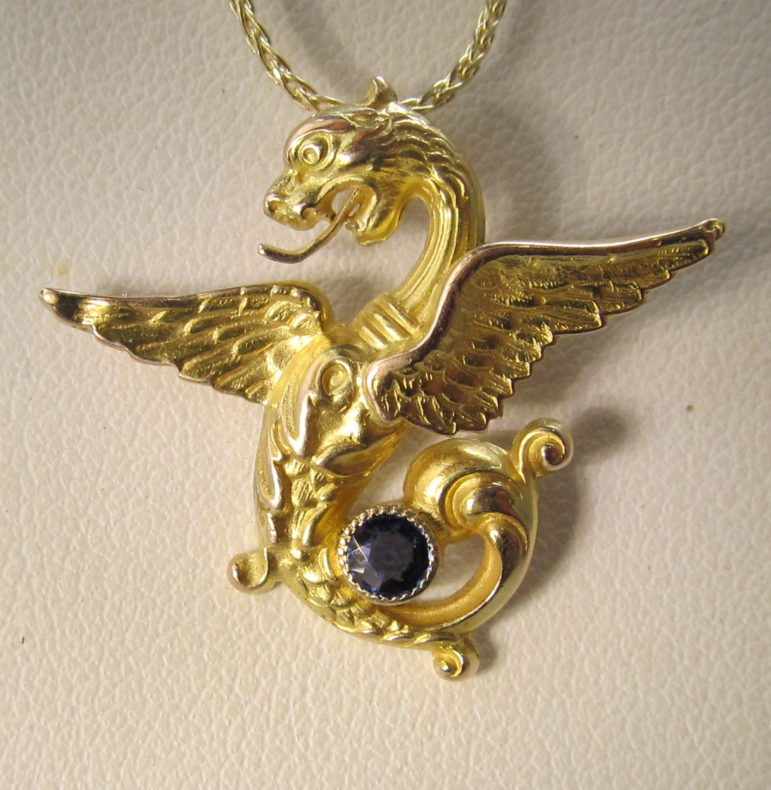 Antique 14k yellow gold griffin necklace with a sapphire, circa 1900