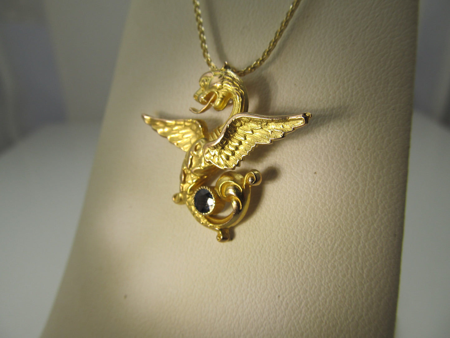 Antique 14k yellow gold griffin necklace with a sapphire, circa 1900