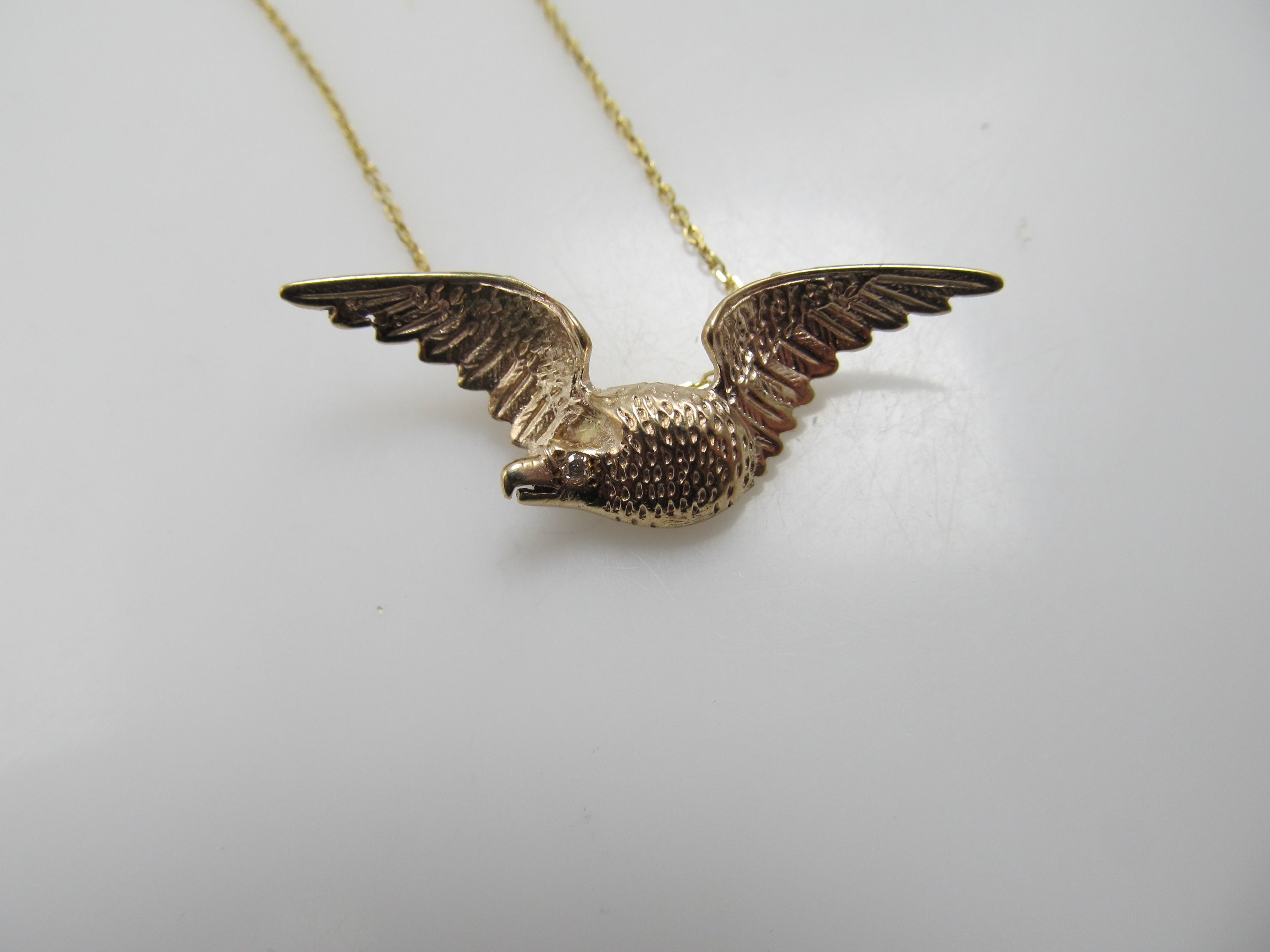 14k rose gold eagle necklace with a diamond eye, circa 1900.