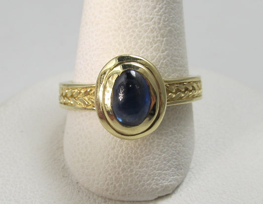 14k yellow gold ring with a cabochon cut sapphire
