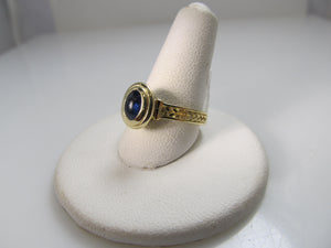 14k yellow gold ring with a cabochon cut sapphire