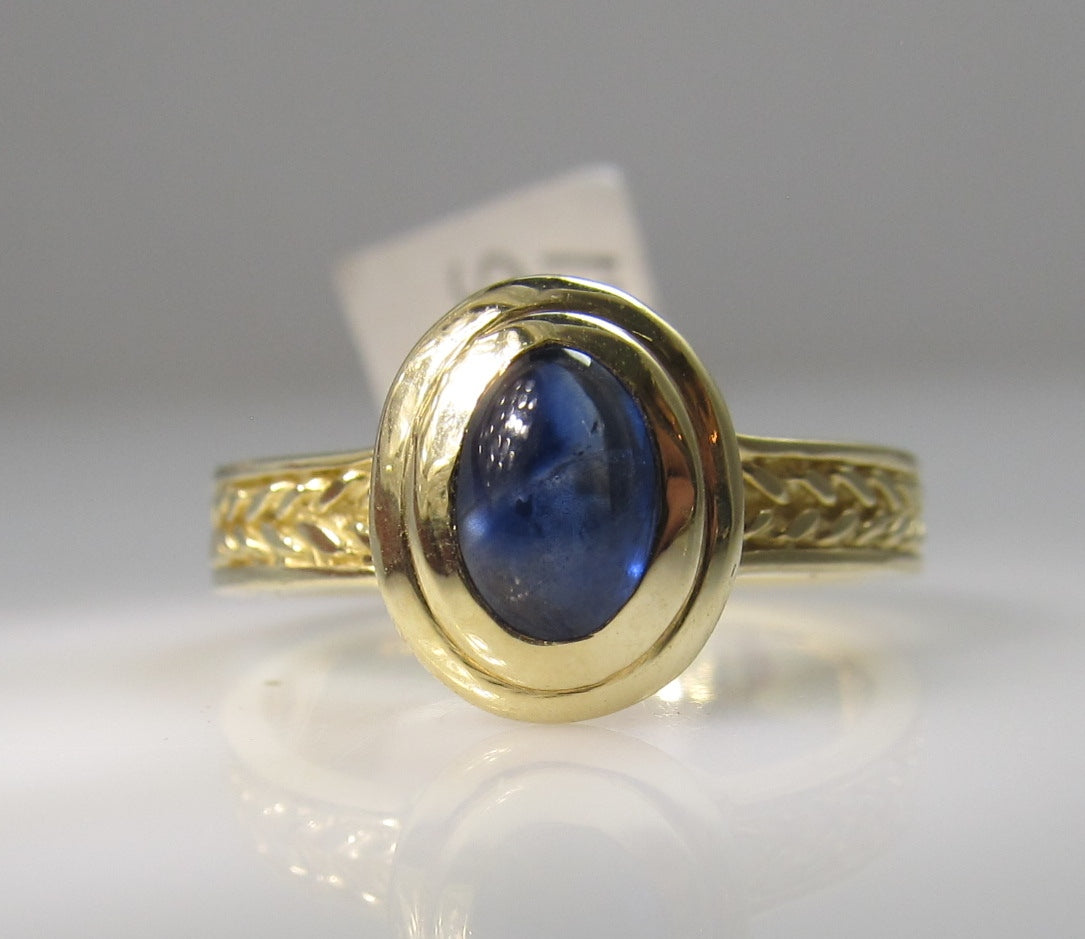 14k yellow gold ring with a cabochon cut sapphire
