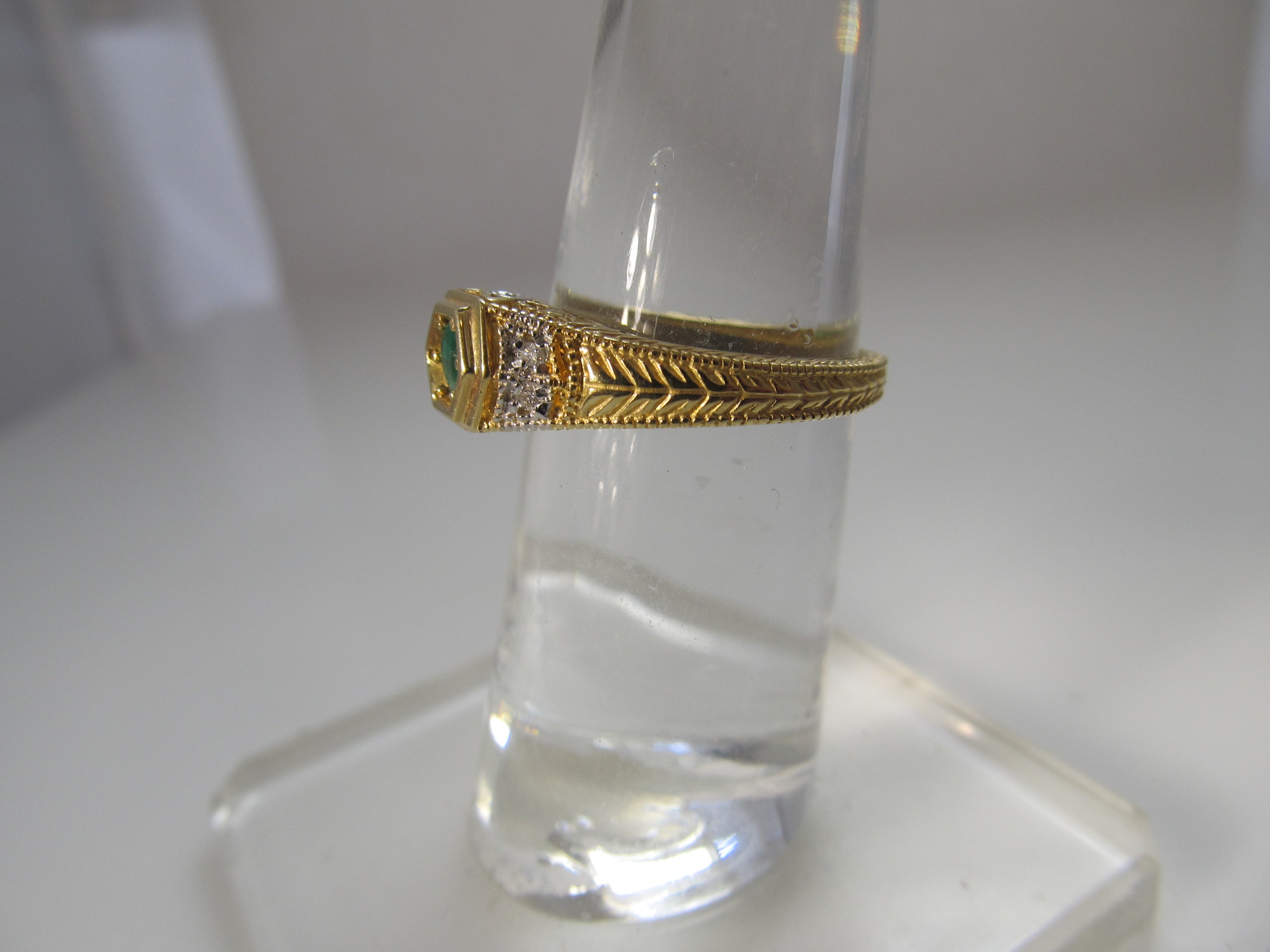 Yellow gold emerald and diamond ring