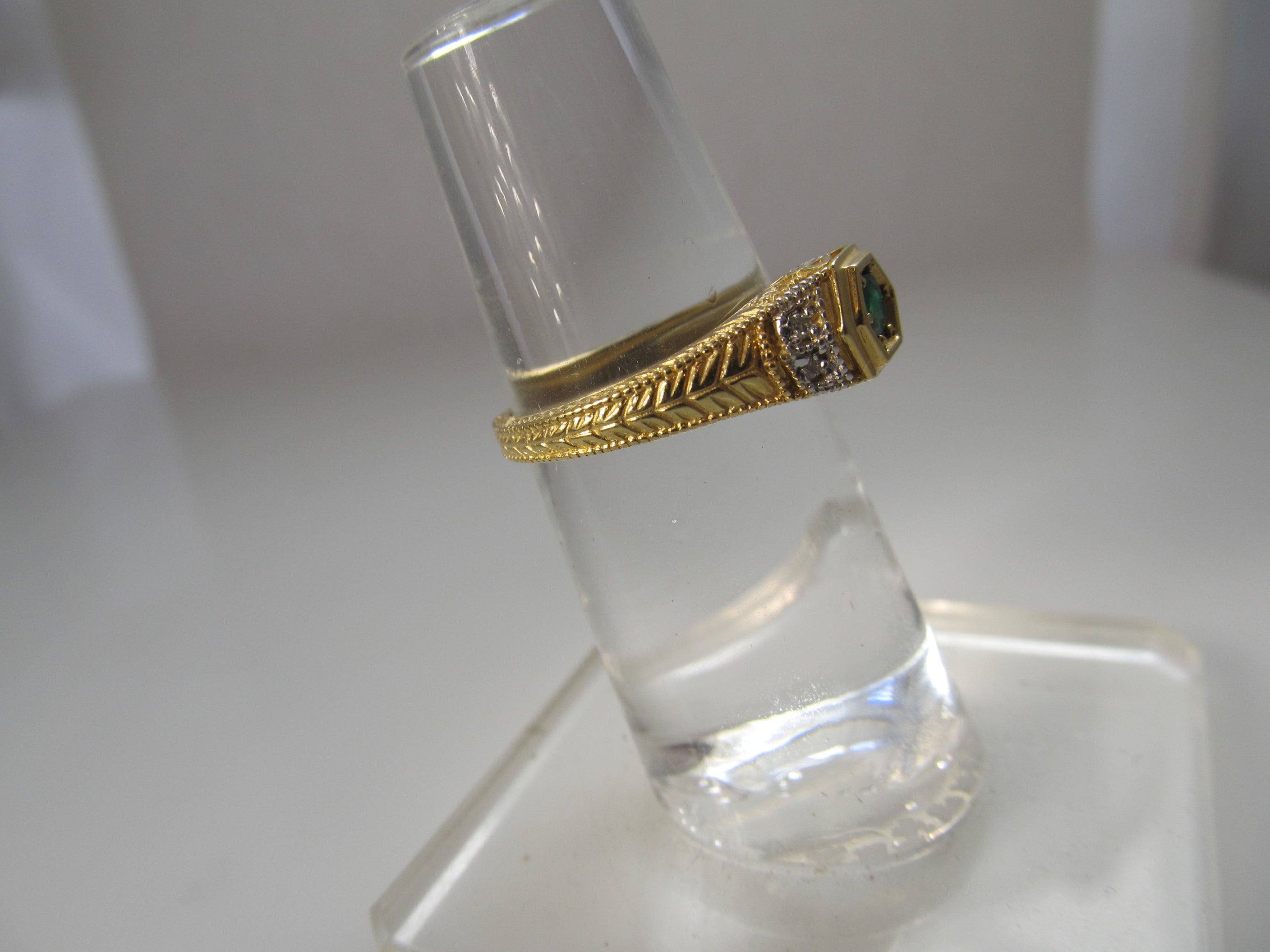 Yellow gold emerald and diamond ring