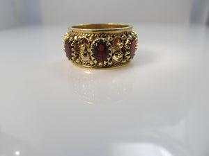 Wide garnet eternity band in 14k yellow gold, size 9 1/2