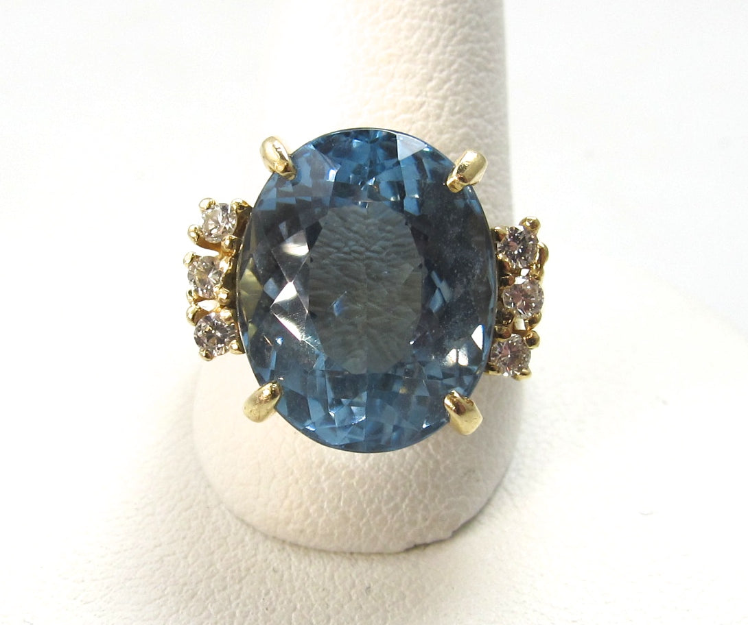 14k yellow gold ring with diamonds and a 8.50ct blue topaz