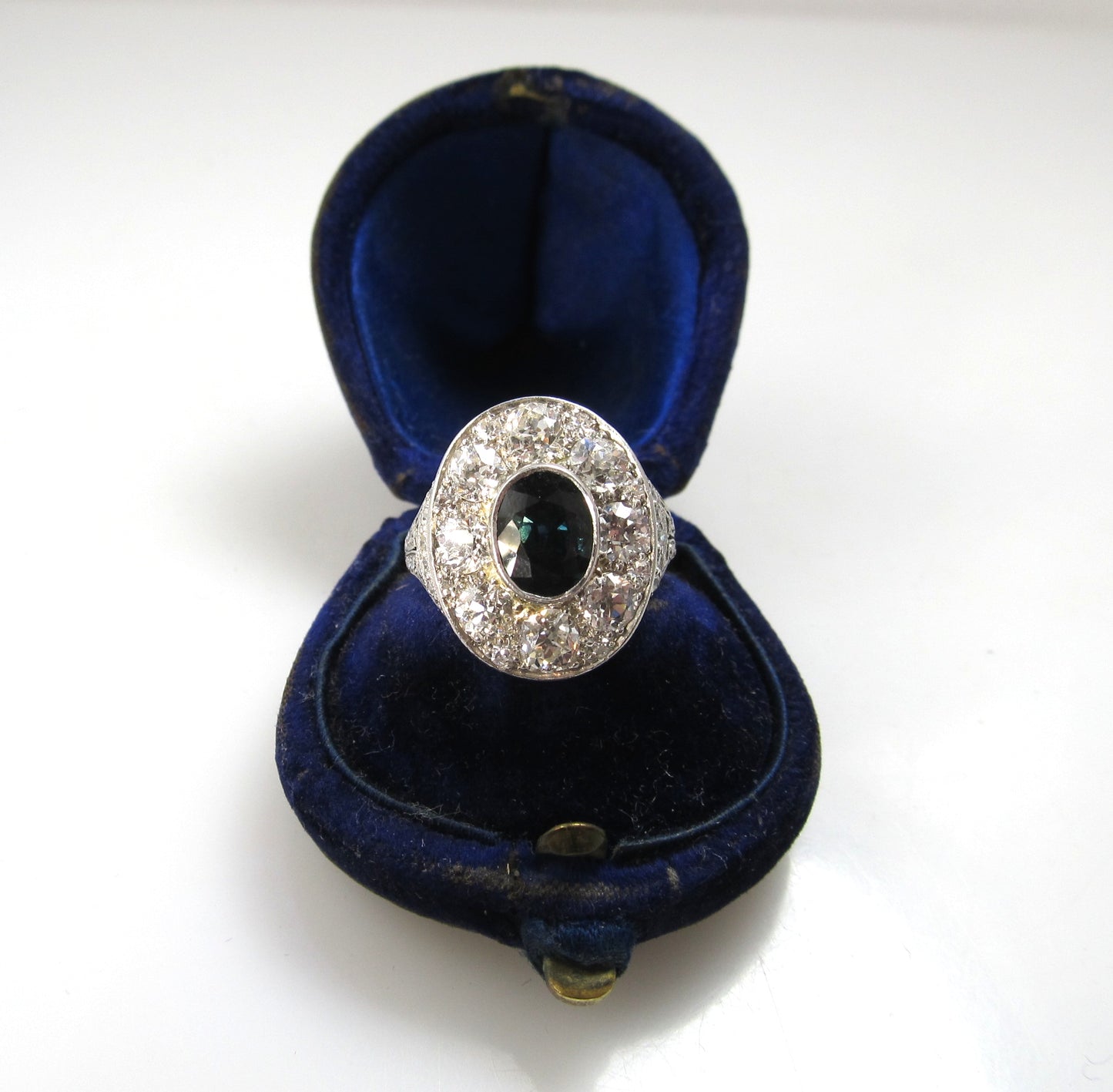 Antique platinum filigree statement ring with diamonds and a sapphire, circa 1920