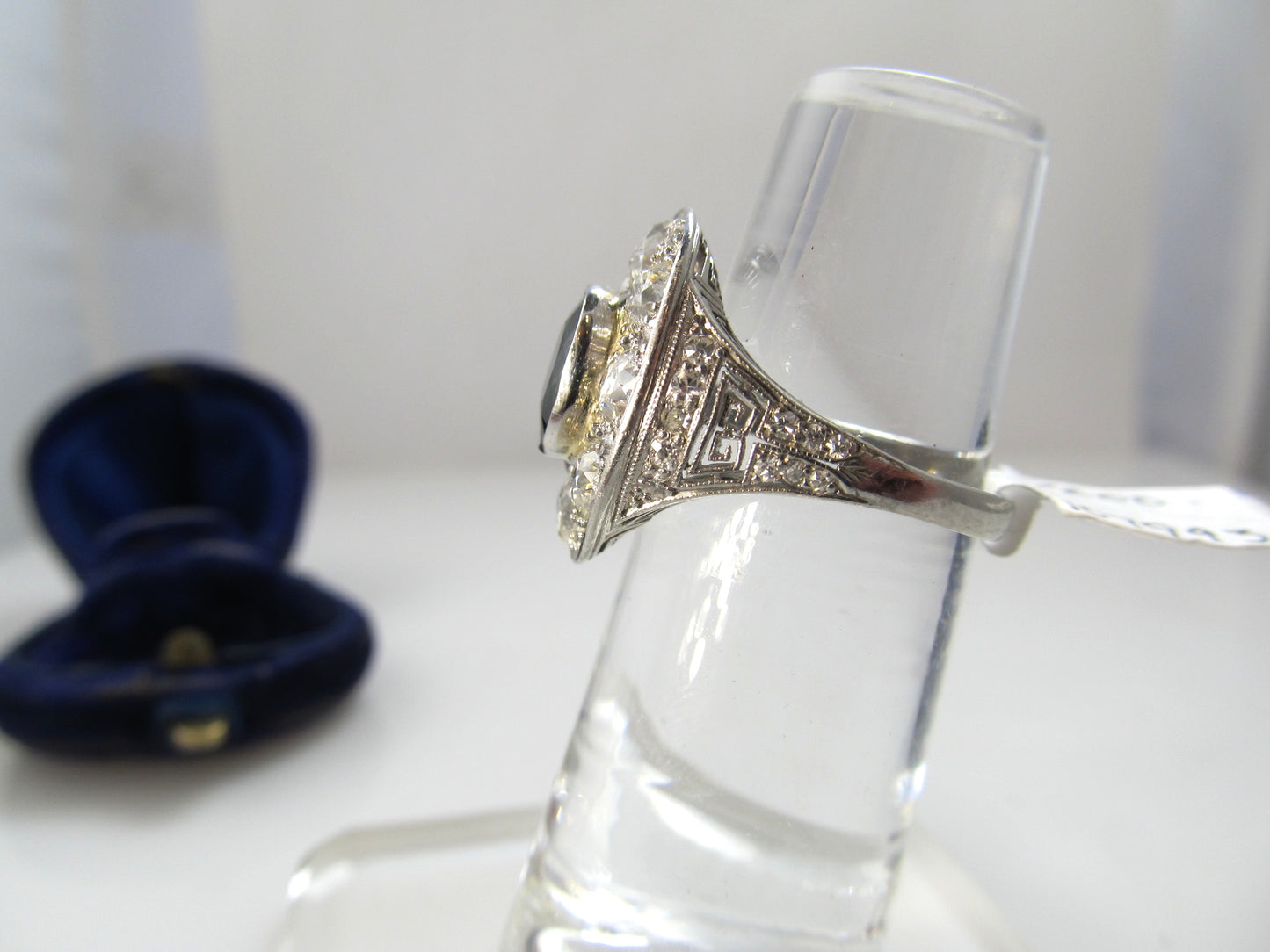 Antique platinum filigree statement ring with diamonds and a sapphire, circa 1920