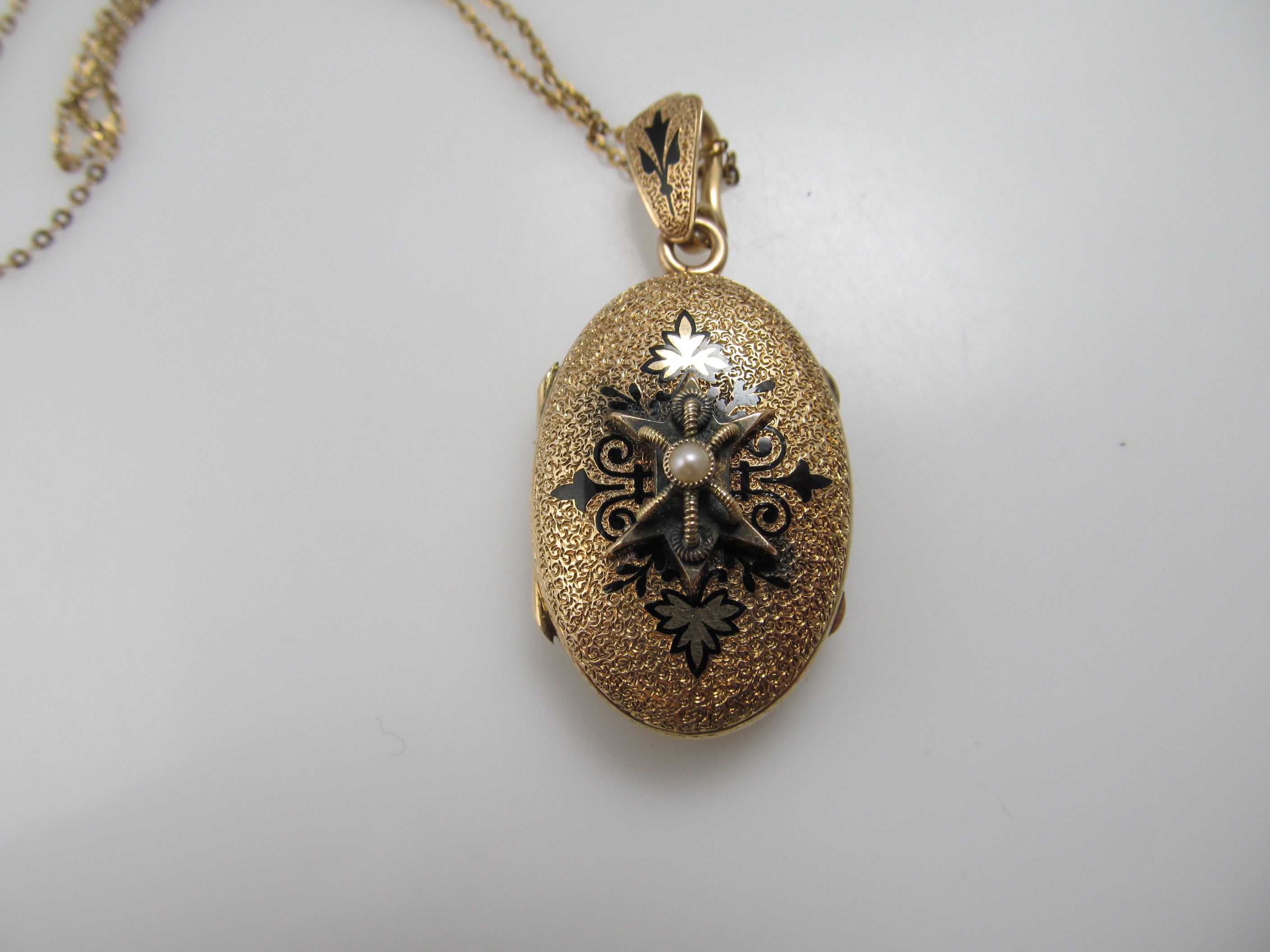 Victorian gold locket with enamel and a pearl