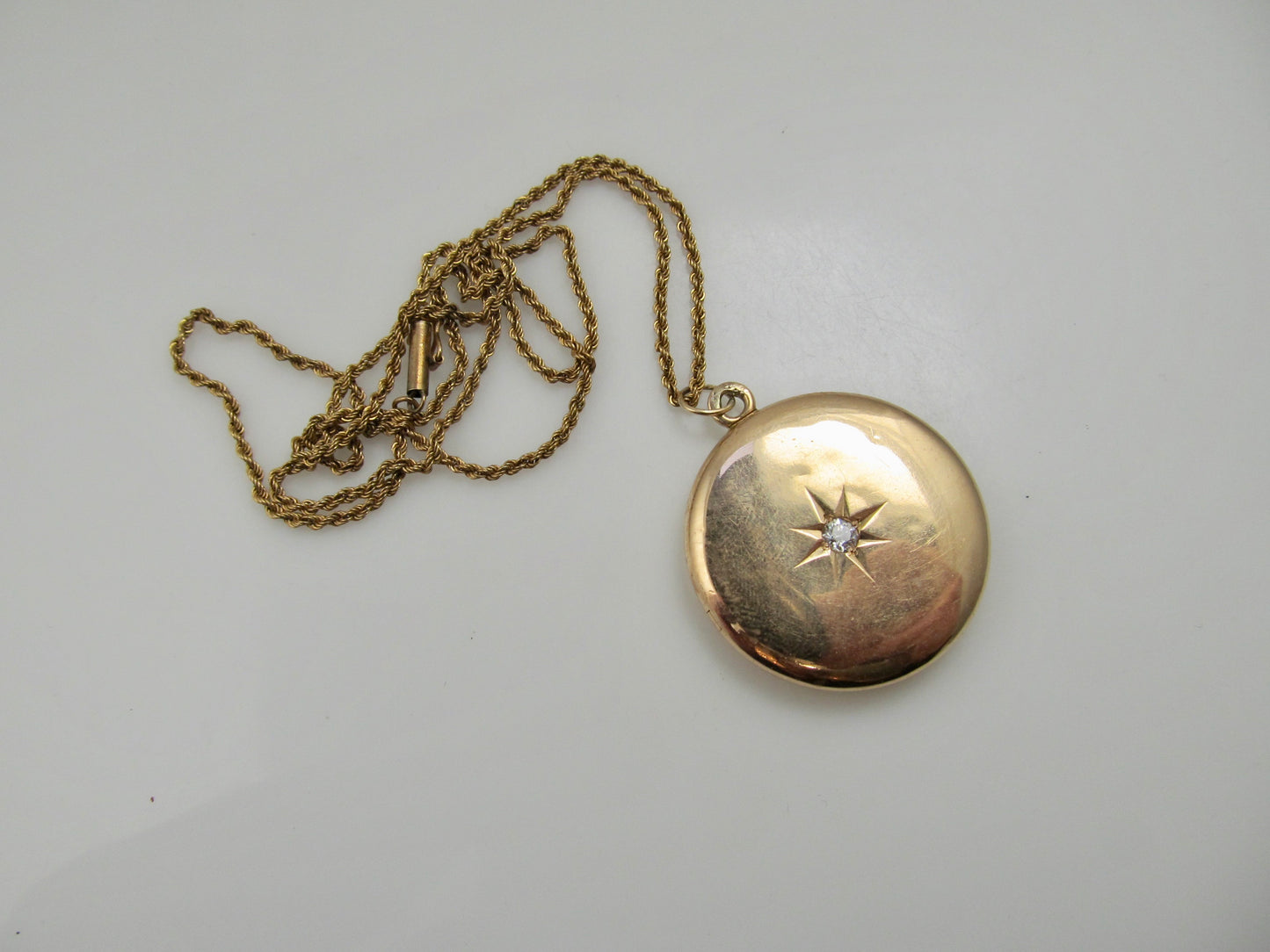 Antique 14k rose gold locket with a star set diamond