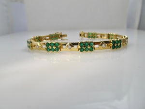 14k yellow gold line bracelet with emeralds and diamonds