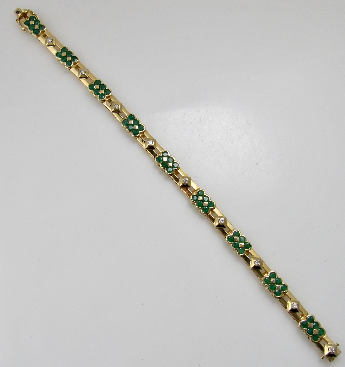 14k yellow gold line bracelet with emeralds and diamonds
